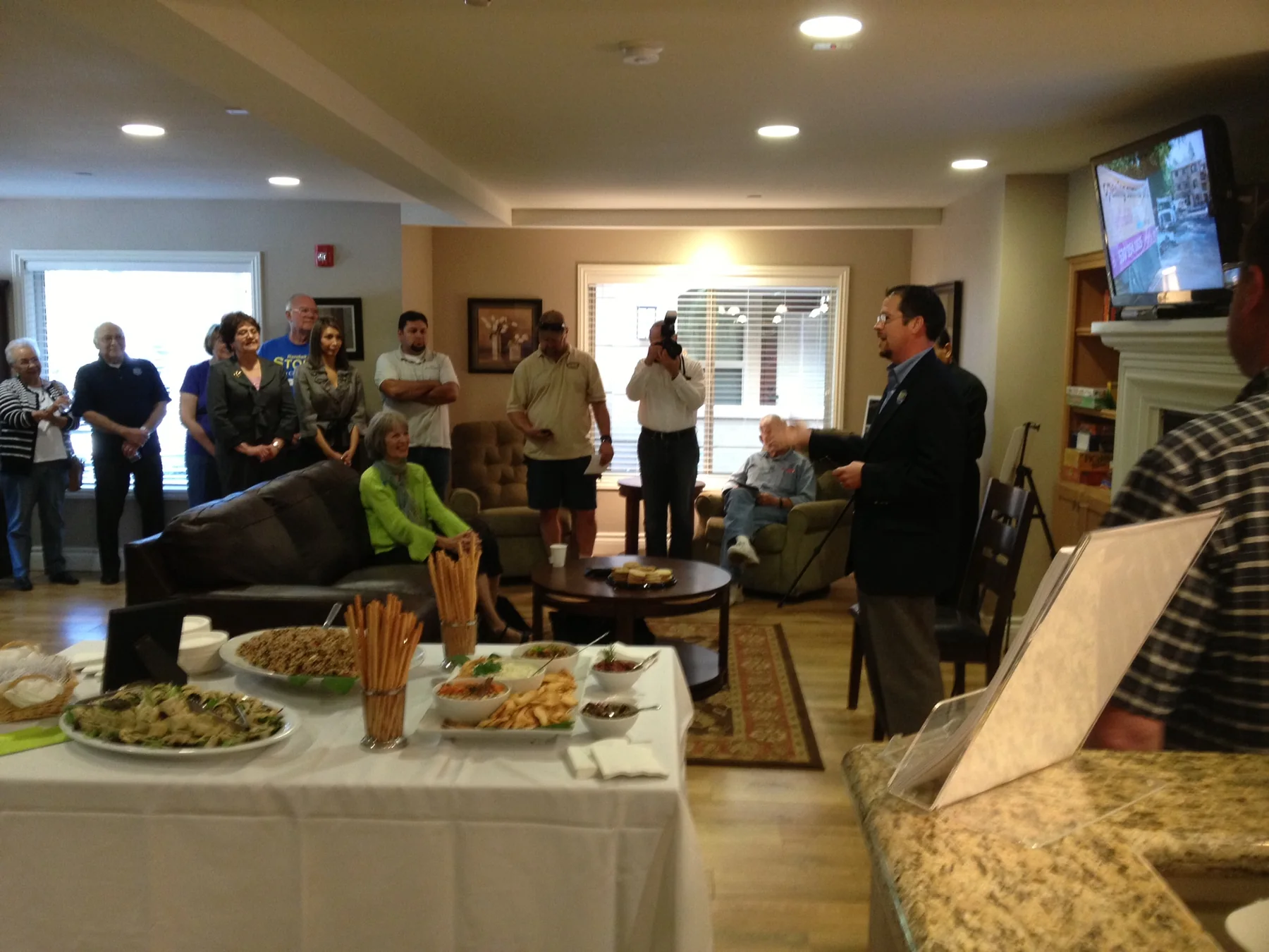 Randall Stone speaking inside the Bidwell Park Apartments community room during the opening