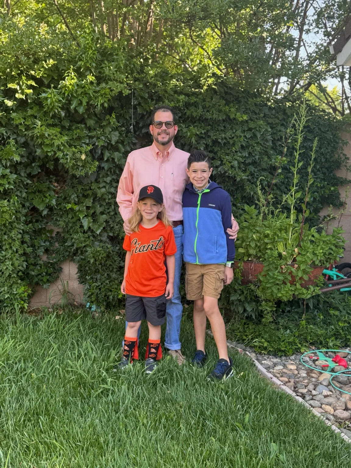 Randall Stone with his sons outdoors at home