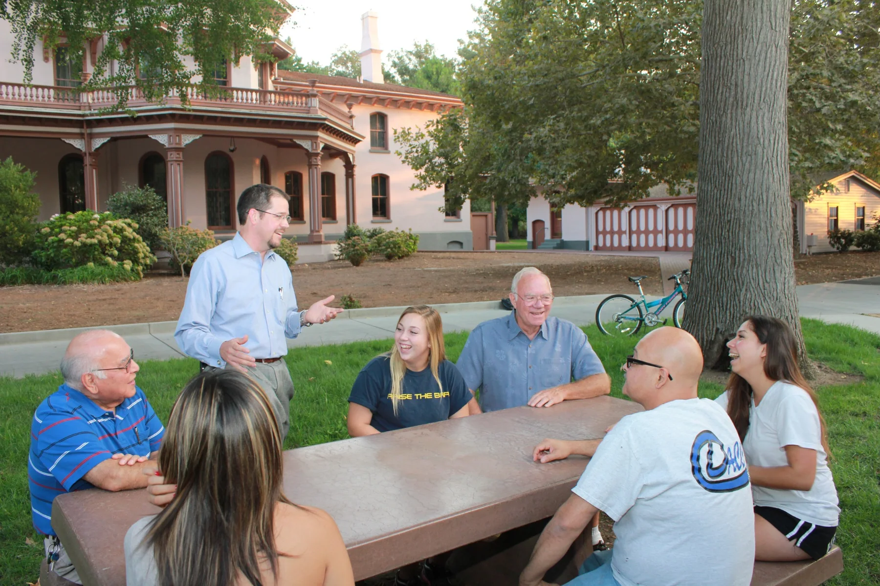 Randall Stone in conversation around a community table