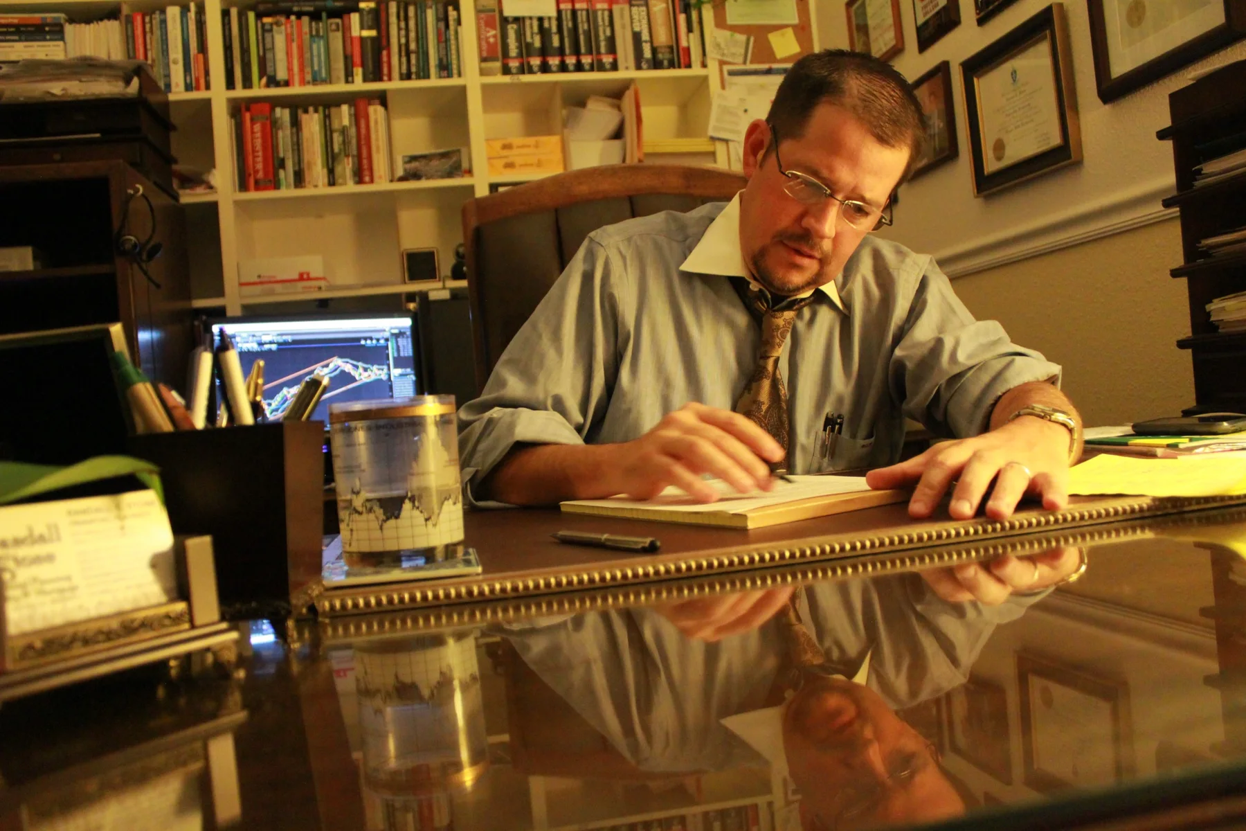 Randall Stone reviewing financial work at his desk